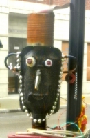 Face detail, 3 Stars Auto Body sidewalk muffler man in July 2011. Lawrence Avenue near Sacramento, Chicago