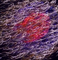 Red, purple and whitish squiggles fireworks closeup