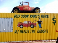 Buy Your Parts Here V-J Needs the Dough! fence  painting with car and actual car above. Frank's West Side Auto Parts, Kedzie at 30th Street