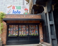 Front window, Lucy Sparrow's 8 'till late all-felt convenience store, on LIttle West 12th Street, under the High Line in New York.