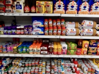 Shelves of groceries. All felt all the time. Lucy Sparrow's 8 'till late convenience store, on LIttle West 12th Street, under the High Line in New York.