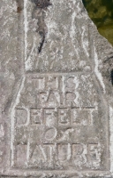 Odd figure, This Fair Defect of Nature, from 12-panel carving. Chicago Lakefront stone carvings, south of La Rabida Hospital. 2023