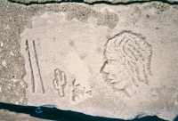 Profile, cactus and symbols. Lost. Chicago lakefront stone carvings, south of Montrose Harbor. Before 2002