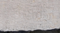Possibly nip + cy, with figure, fire-breathing C or flower. Chicago lakefront stone carvings, Montrose Beach. 2020 Possibly nip + cy, with figure, fire-breathing C or flower. Chicago lakefront stone carvings, Montrose Beach. 2020