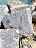 Scratched-out pair, W., MEL, Bud, E, Bill, others. Chicago lakefront stone carvings, south of La Rabida Hospital. 2026