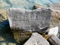 Autograph rock: 7/9/33, Al T, John Gel, Ira, RFK, undecipehred, Stan. D., GZ, R(?), C, T, A, Enr 19, 8, Jim K. Chicago lakefront stone carvings, south of La Rabida Hospital. 2026