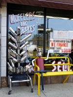 Muffler tree and another muffler person relaxing at 6 Stars Auto Body in July 2014. Lawrence Avenue near Sacramento, Chicago