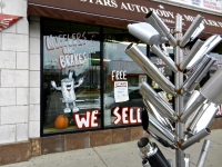 Muffler tree and window at 6 Stars Auto Body in November 2011, Lawrence Avenue near Sacramento, Chicago