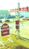 Gesturing muffler person, Jesus' Muffler Shop, Greenville NC, courtesy of Luke Whisnant