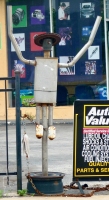 Wide-brimmed, short-legged muffler person, Lawrence Auto Works, Lawrence Avenue at Kenneth, Chicago