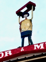 Mighty muffler person atop Ramon's Automotive, South Tucson, Arizona