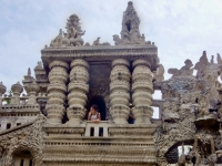 Visitor peering from Le Palais Idéal du Facteur Cheval, Hauterives, France