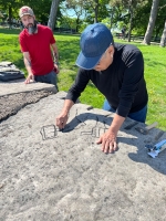 Roman Villareal  draws the outline for a carving while Joel Cardenas looks on.