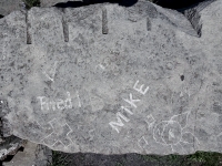 V, cross, shapes made at the June 20, 2026, DIY carving workshop added to rock with JC, Friedl, Mike. Chicago lakefront stone carvings, Promontory Point. 2026