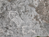 Circle, jellyfish, Z, smiley face, EMS. The jellyfish and EMS are from earlier workshops. Other carvings were made at the June 20, 2026, DIY carving workshop. Chicago lakefront stone carvings, Promontory Point. 2026