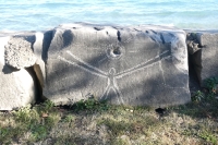 Figure with sun, with face on the right, by Joel Cardena, made during the Oct. 9, 2022, Promontory Point carving workshop. Chicago Lakefront stone carvings, Promontory Point. 2022