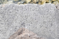 Winged figure (left), Shoes. Level 1. Chicago lakefront stone carvings, Promontory Point. 2022