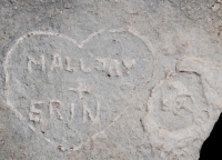 Heart with Mallory + Erin, dog face carvings by Mallory Price of the Hyde Park Historical Society. Level 5. Chicago lakefront stone carvings, Promontory Point. 2022