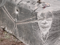 Joel Cardenas completed this face during Promontory Point festivities in May 2023, next to his figure with sun from October 2022. Level 5, vertical. Chicago lakefront stone carvings, Promontory Point. 2023 Joel Cardenas completed this face during Promontory Point festivities in May 2023, next to his figure with sun from October 2022. Level 5, vertical. Chicago lakefront stone carvings, Promontory Point. 2023