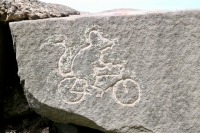 Rat on a bike, made by Matt Bergstrom during the carving workshop led by Roman Villareal and Joel Cardenas, May 28, 2022. Level 5, vertical. Chicago lakefront stone carvings, Promontory Point. 2022