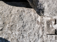 Jake, Fuck, Jim, V, deep cut shapes, C. Fogle (detail). Chicago Lakefront stone carvings, south of La Rabida Hospital. 2025 Jake, Fuck, Jim, V, deep cut shapes, C. Fogle (detail). Chicago Lakefront stone carvings, south of La Rabida Hospital. 2025