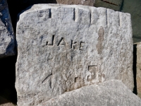 Jake, Fuck, Jim, V, deep cut shapes, C. Fogle. Chicago Lakefront stone carvings, south of La Rabida Hospital. 2025 Jake, Fuck, Jim, V, deep cut shapes, C. Fogle. Chicago Lakefront stone carvings, south of La Rabida Hospital. 2025