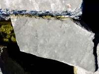 Faint writing. Chicago lakefront stone carvings, Rainbow Beach jetty. 2022