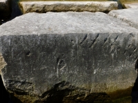 Fancy script on vertical surface. Chicago lakefront stone carvings, Rainbow Beach jetty. 2022