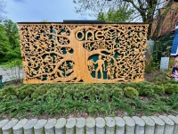 Elaborate carving behind a package pickup locker, Krakow