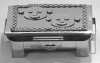 Stanley Szwarc stainless steel face box two cartoonish faces, front view