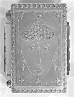 Stanley Szwarc stainless steel face box with dotty hair and earrings