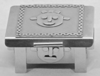 Stanley Szwarc stainless steel small face box with cartoonish face, front view