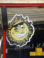 Painted sun, City Tire, Lincoln near Carmen, Chicago-Roadside Art