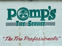 Painted sign on back of a truck for Pomp's Tire Service-Roadside Art