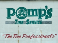 Painted sign on back of a truck for Pomp's Tire Service-Roadside Art