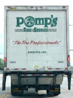 Painted sign on back of a truck for Pomp's Tire Service-Roadside Art