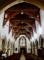 Looking toward the font in St. John the Baptist Church, Bere Regis, England. Above is the spectacular 15th century roof.