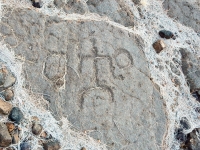 Stick figure between two circles from the Waikoloa petroglyphs in Hawaii Stick figure between two circles from the Waikoloa petroglyphs in Hawaii