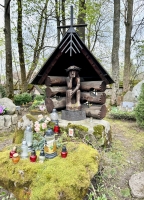 Pensive Jesus, mossy rocks, rustic enclosure, abstracted cross. A lot to love
