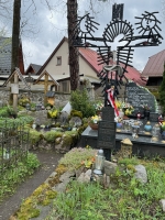 Cross with moon, sun and religious figure, apparently made with rebar