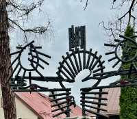 Cross with moon, sun and religious figure, apparently made with rebar, detail