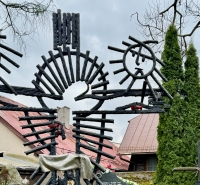 Cross with moon, sun and religious figure, apparently made with rebar, detail