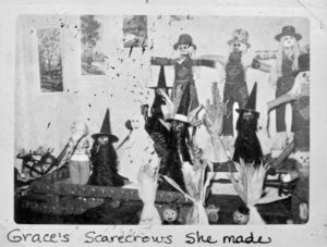 Halloween scarecrows by Grace Woolsey, on a bottle-cap cart and sleigh