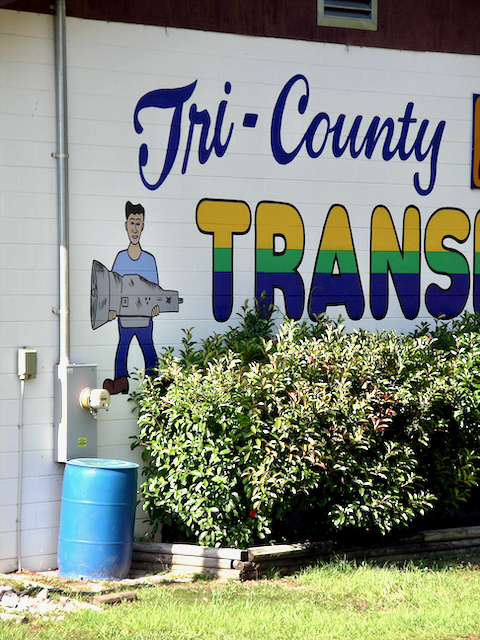 Mechanic holding a transmission at Tri-County Transmission