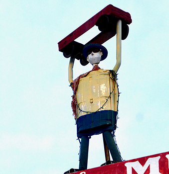 South Tucson muffler man holding a car-roadside art